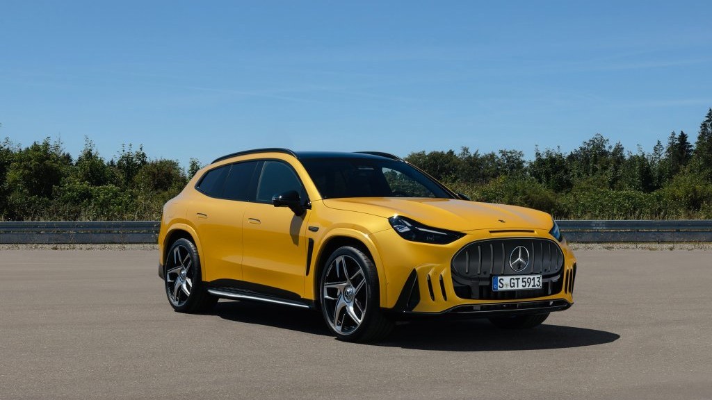 Yellow 2028 Mercedes-AMG GT SUV parked on a test track, front three-quarter view