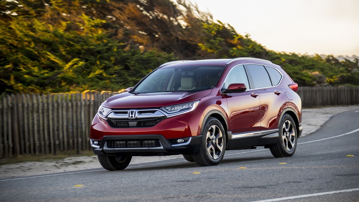 Red 2018 Honda CR-V parked on a coastal road, front three-quarter view