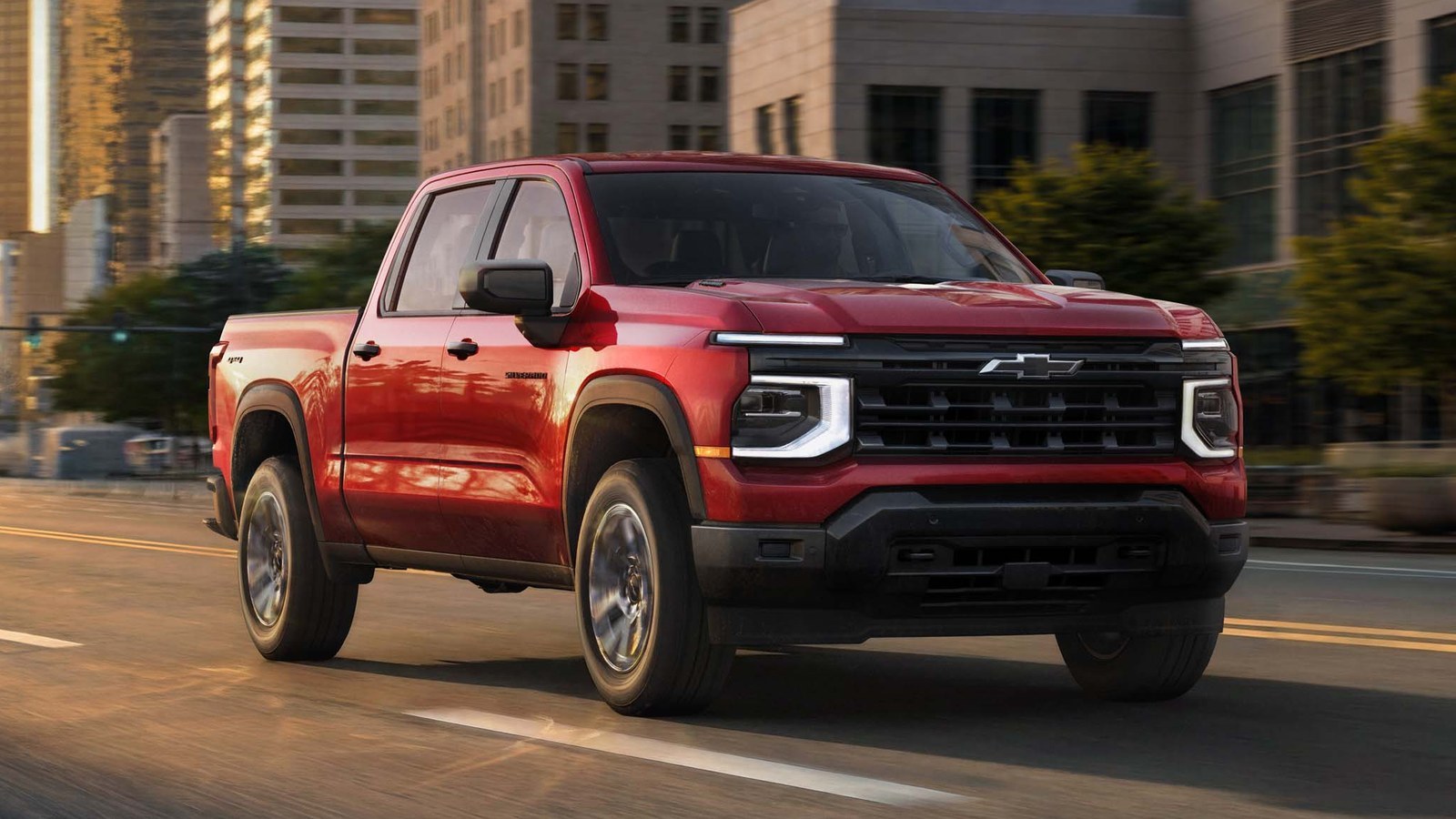 Red 2027 Chevrolet Silverado 1500 Custom crew cab driving on a city street