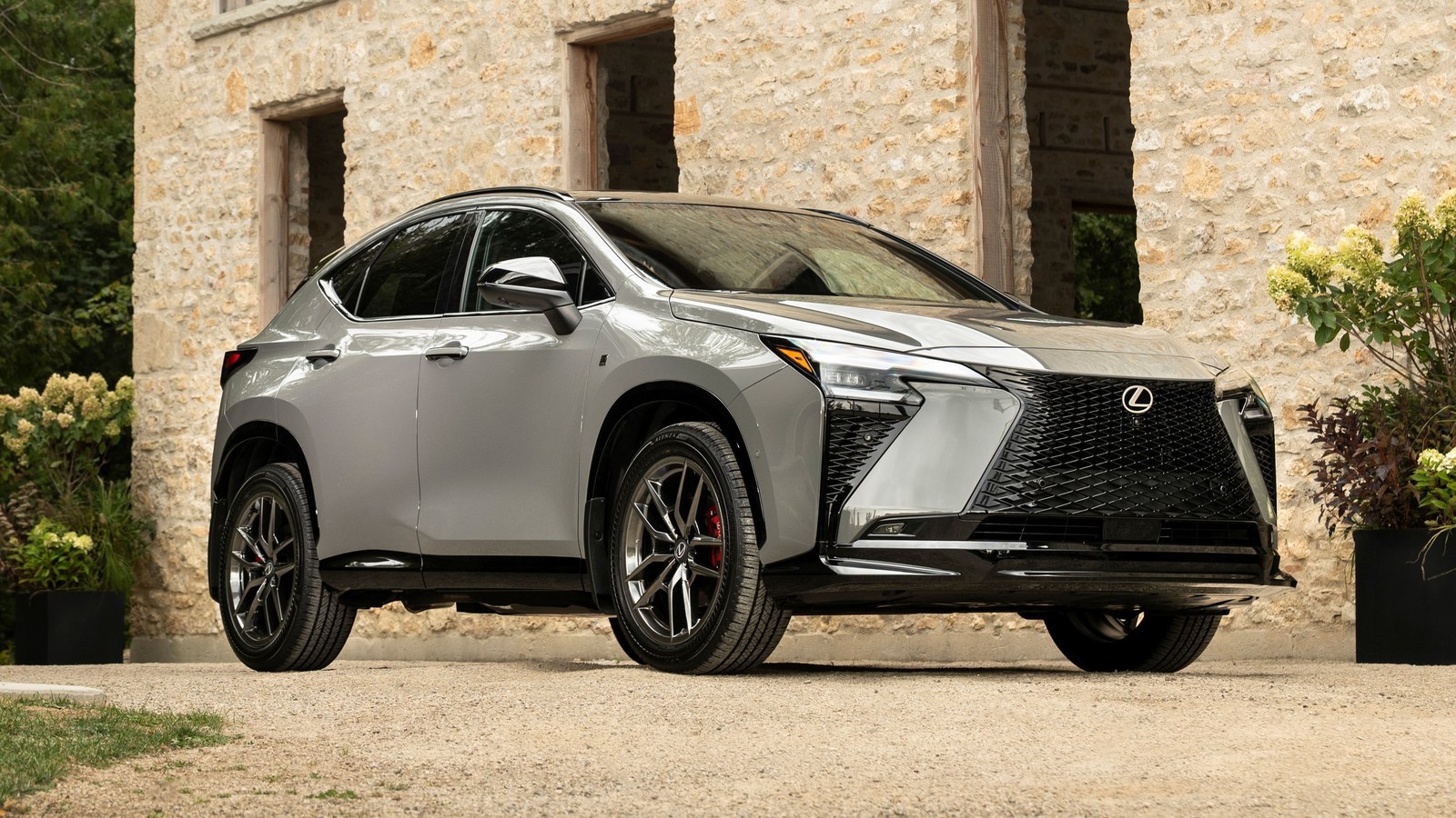 2027 Lexus NX 350h F SPORT in Incognito gray parked in front of a stone building