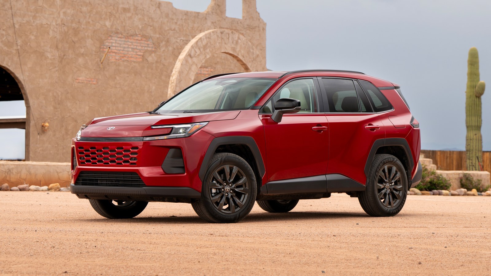 Red 2026 Toyota RAV4 Hybrid XLE Premium parked in front of an adobe wall