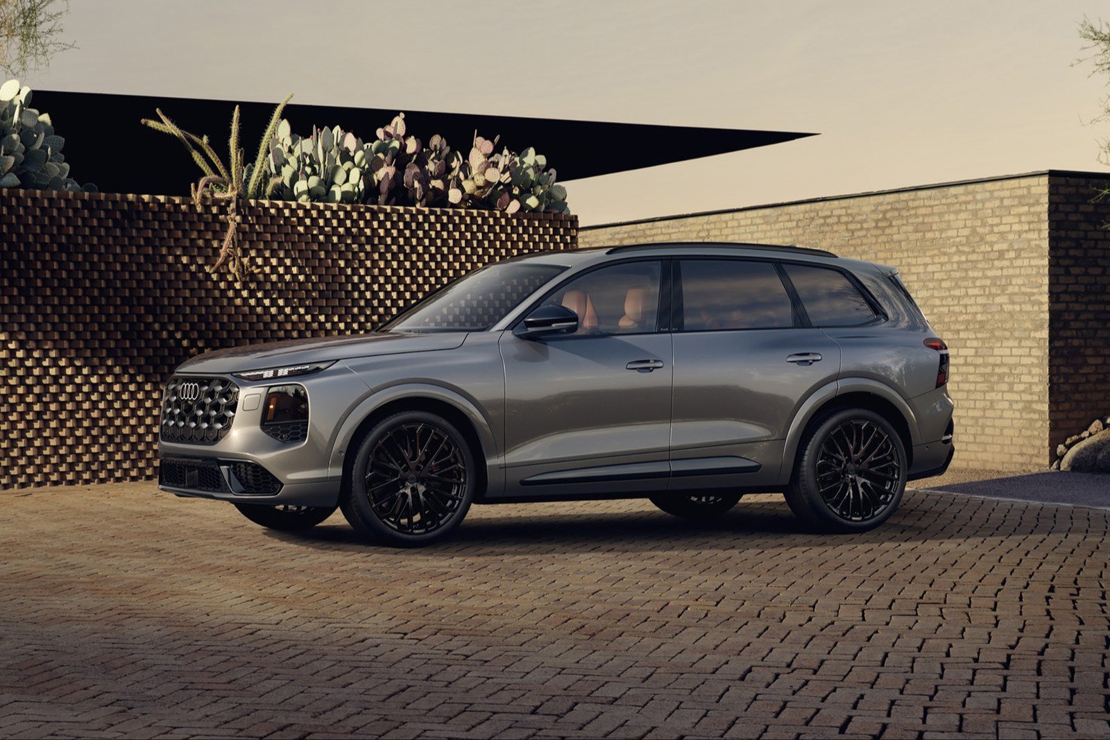 Gray 2027 Audi SQ7 in side profile on a brick courtyard