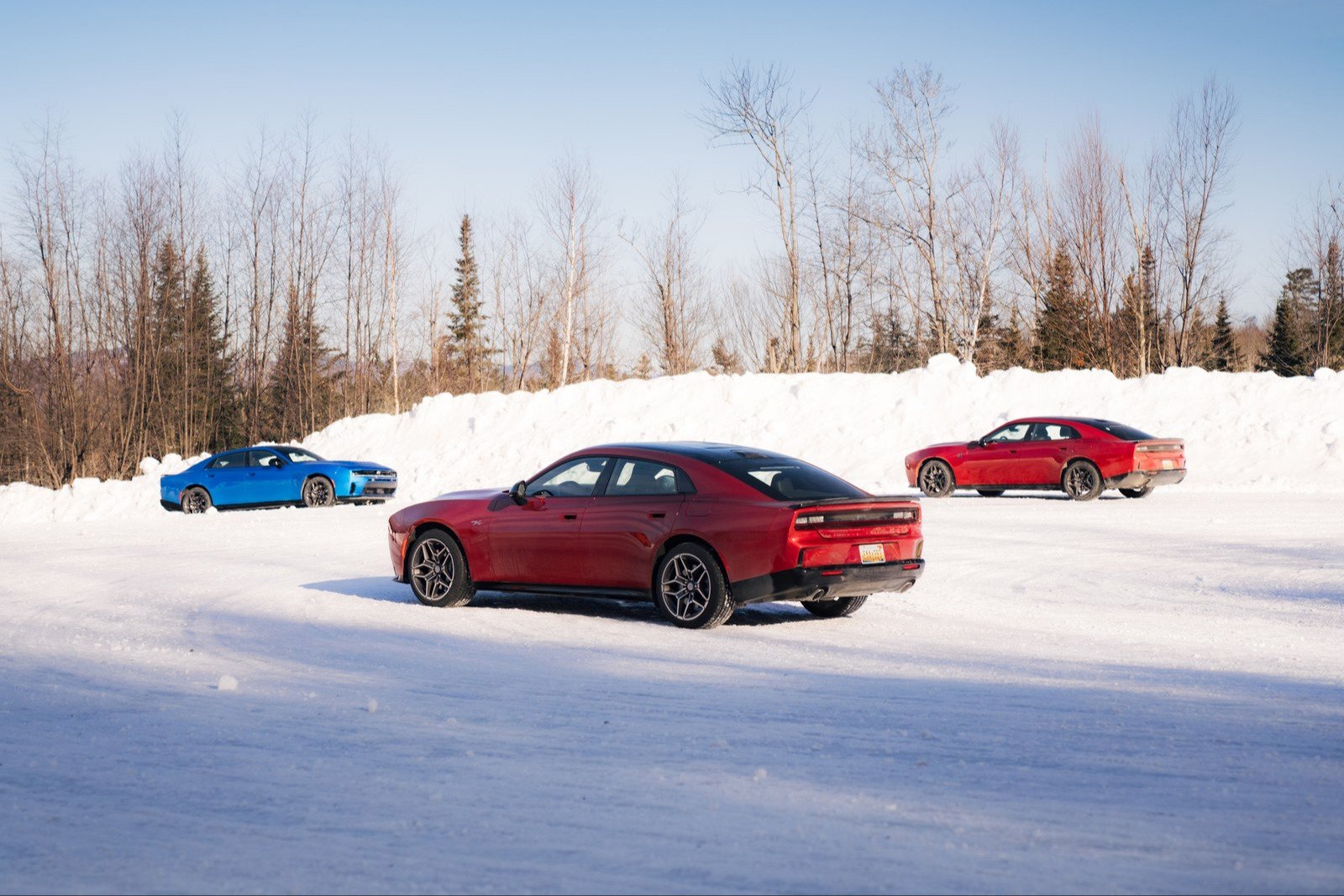 Three gas-powered SIXPACK Dodge Charger models on a snow-covered lot