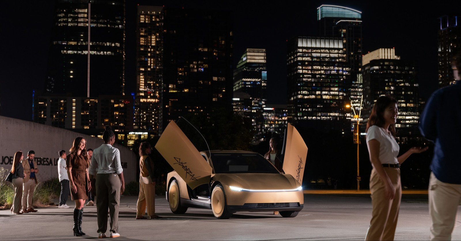 Tesla Cybercab with butterfly doors open in front of the Austin skyline at night