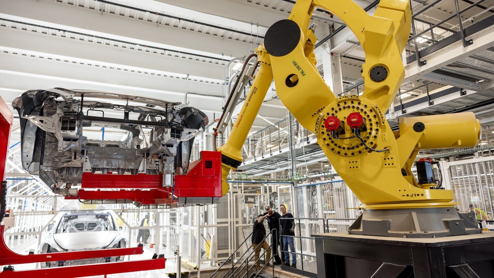 Robot handling a vehicle body on the assembly line at Gigafactory Texas